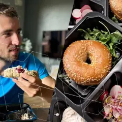 Mężczyzna je posiłek z pudełka, obok widać inne porcje z bajglami, pastą i warzywami. To przykład zbilansowanej diety bogatej w makroelementy.